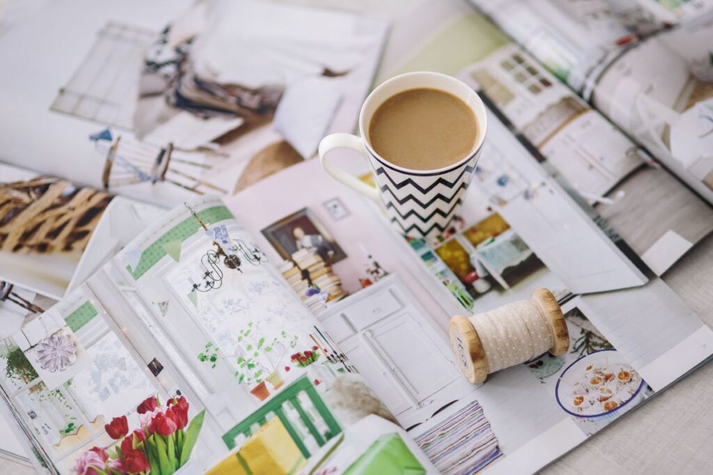 Coffee with home decor magazines Stock Free