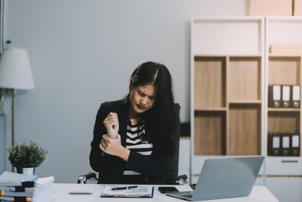 Office asian business woman stretching body for relaxing while working with laptop computer at her desk, office lifestyle, business situation Stock Free