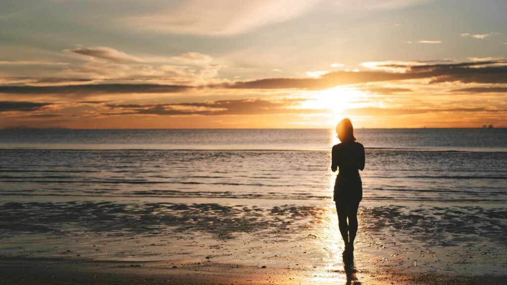 Rear view of young adult travel asian woman relax in nature on beach sea with morning sky Stock Free