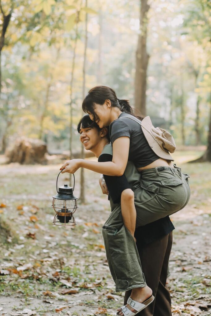 Asian couple sweet in tent inside on they camping trip, traveller relax and sleep togather in out door and camping trip Stock Free