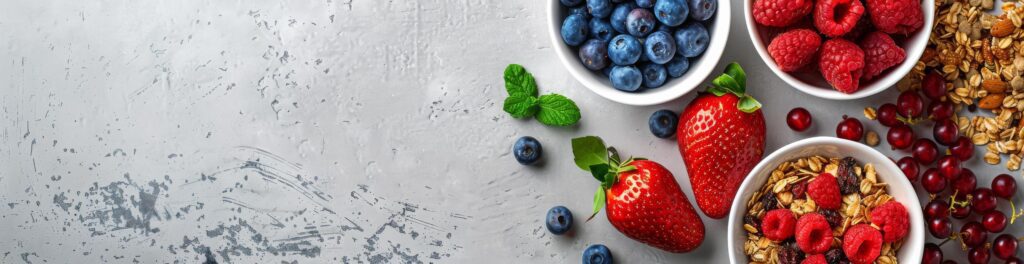 Fresh Berries, Granola, and Strawberries on a Gray Background Stock Free