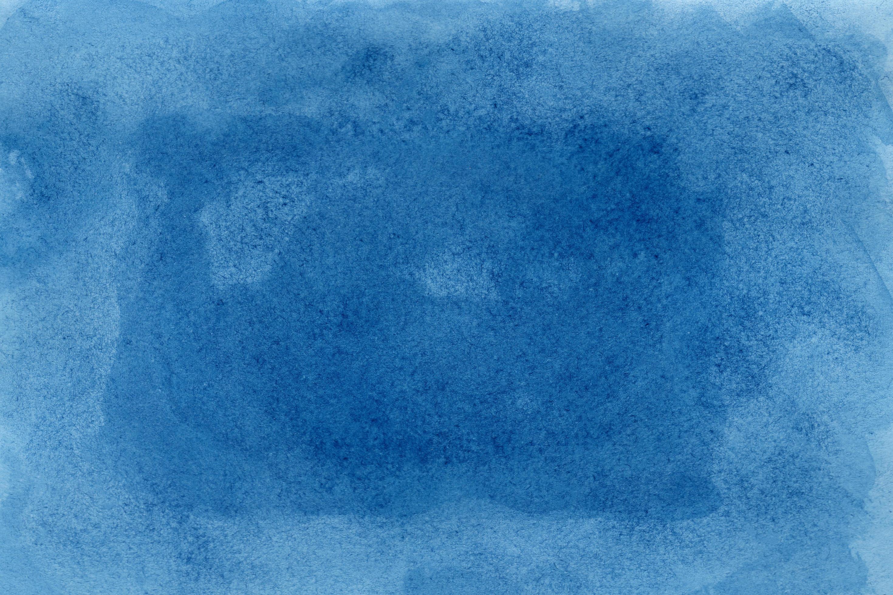 Abstract blue watercolor on white background.The color splashing on the paper.It is a hand drawn. Stock Free