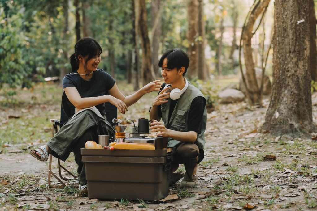 Asian couple sweet in tent inside on they camping trip, traveller relax and sleep togather in out door and camping trip Stock Free