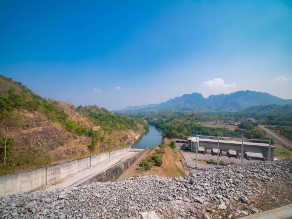 An aerial view of the dam-caused canal in Thailand’s national park, with a mountain the background. Bird eye view. Stock Free