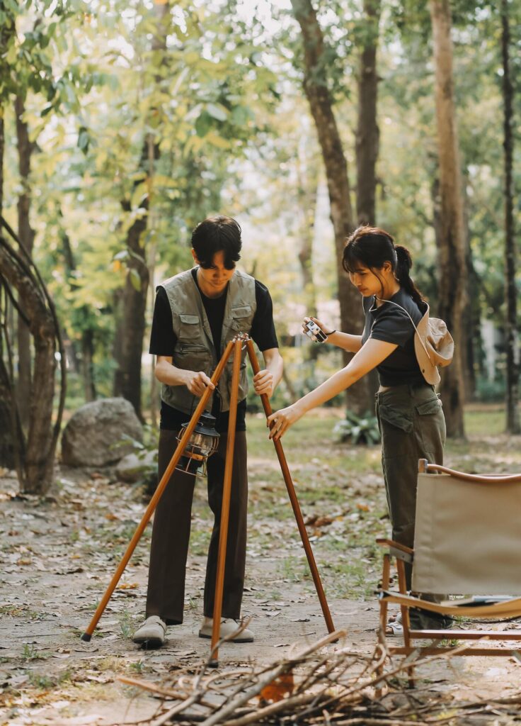 Asian couple sweet in tent inside on they camping trip, traveller relax and sleep togather in out door and camping trip Stock Free