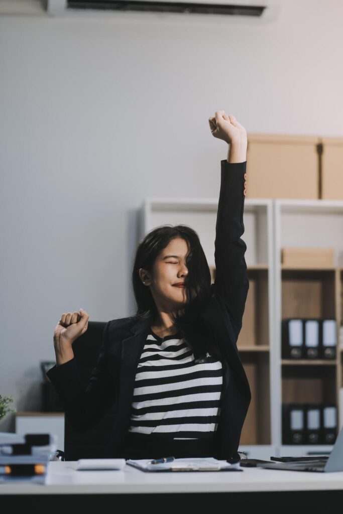 Office asian business woman stretching body for relaxing while working with laptop computer at her desk, office lifestyle, business situation Stock Free