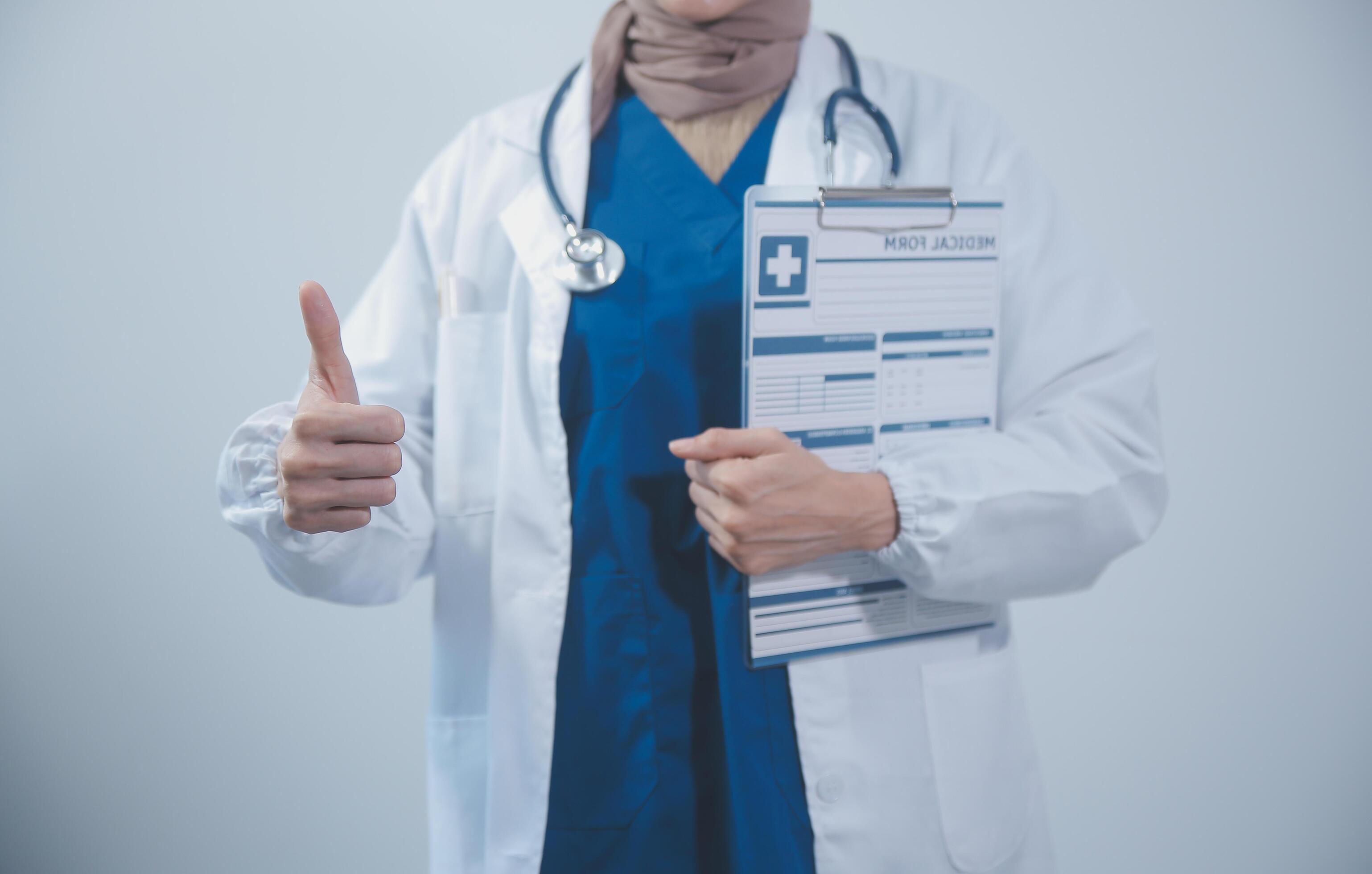 Doctor holding clipboard and stethoscope on background of Hospital ward Stock Free