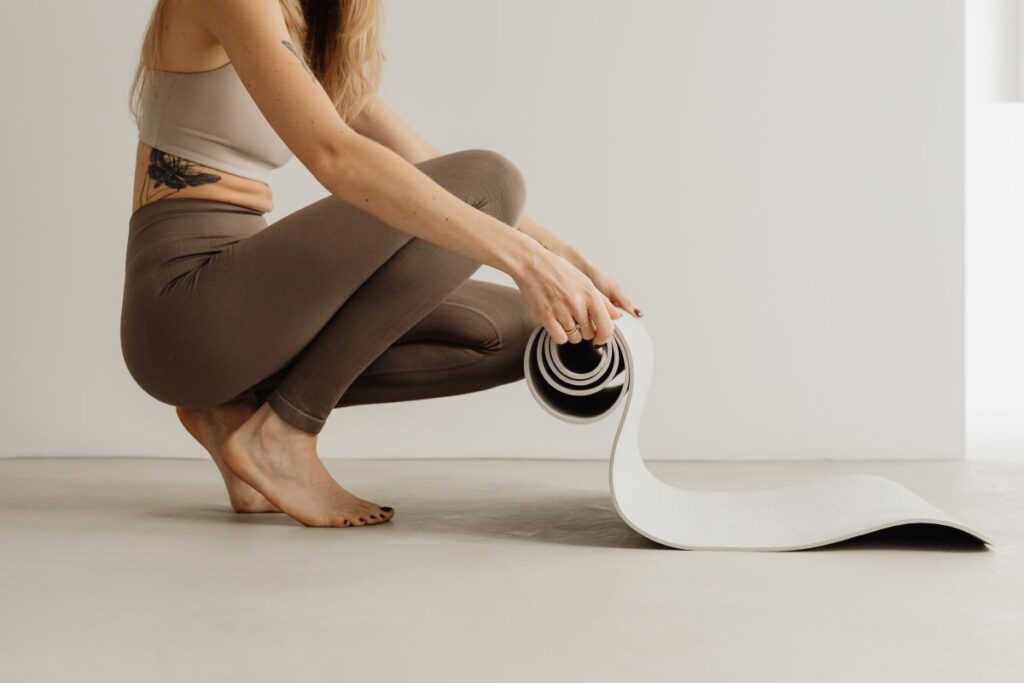 
									Young woman practicing yoga at home Stock Free