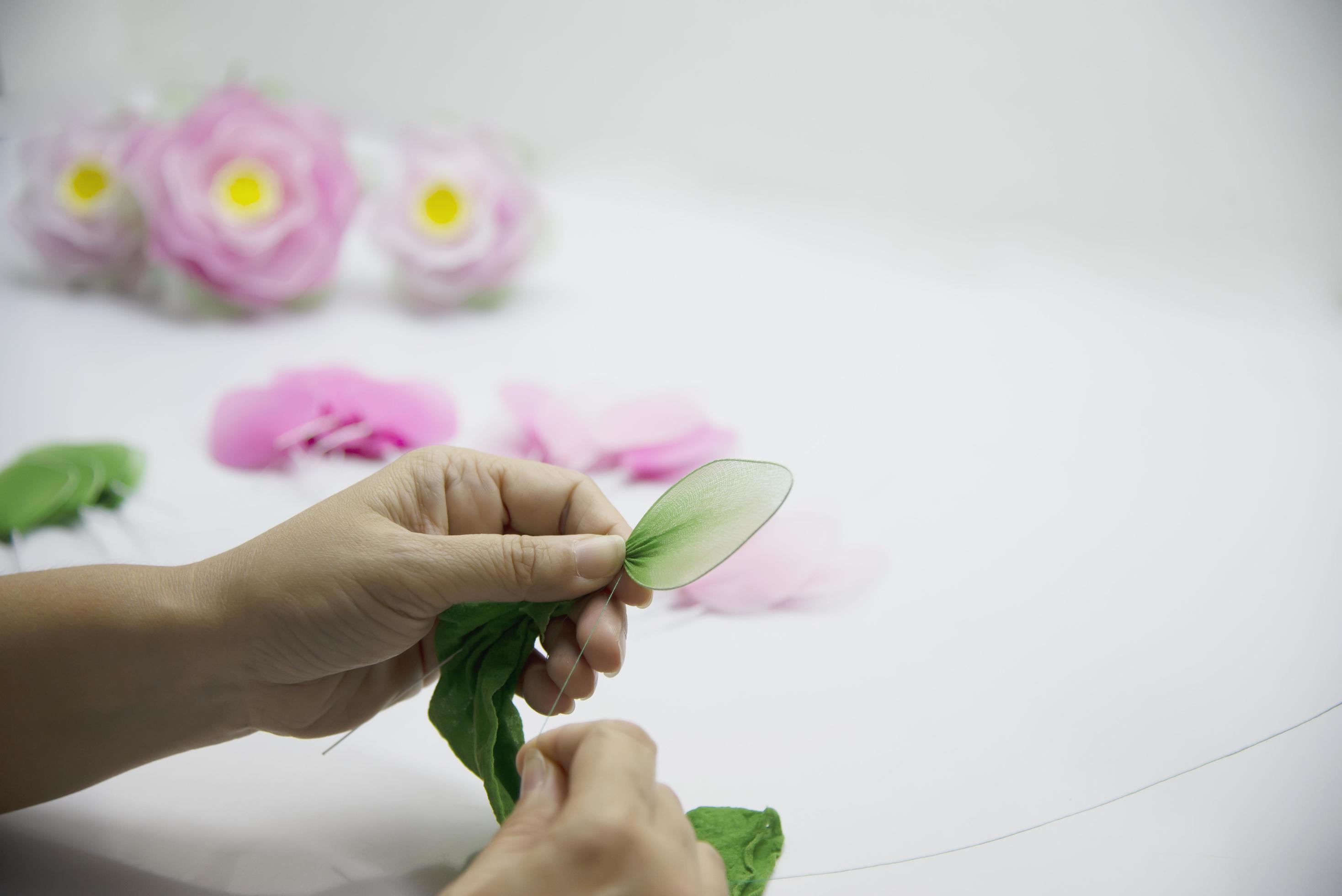 Woman making beautiful nylon flower – people with DIY handmade flower concept Stock Free