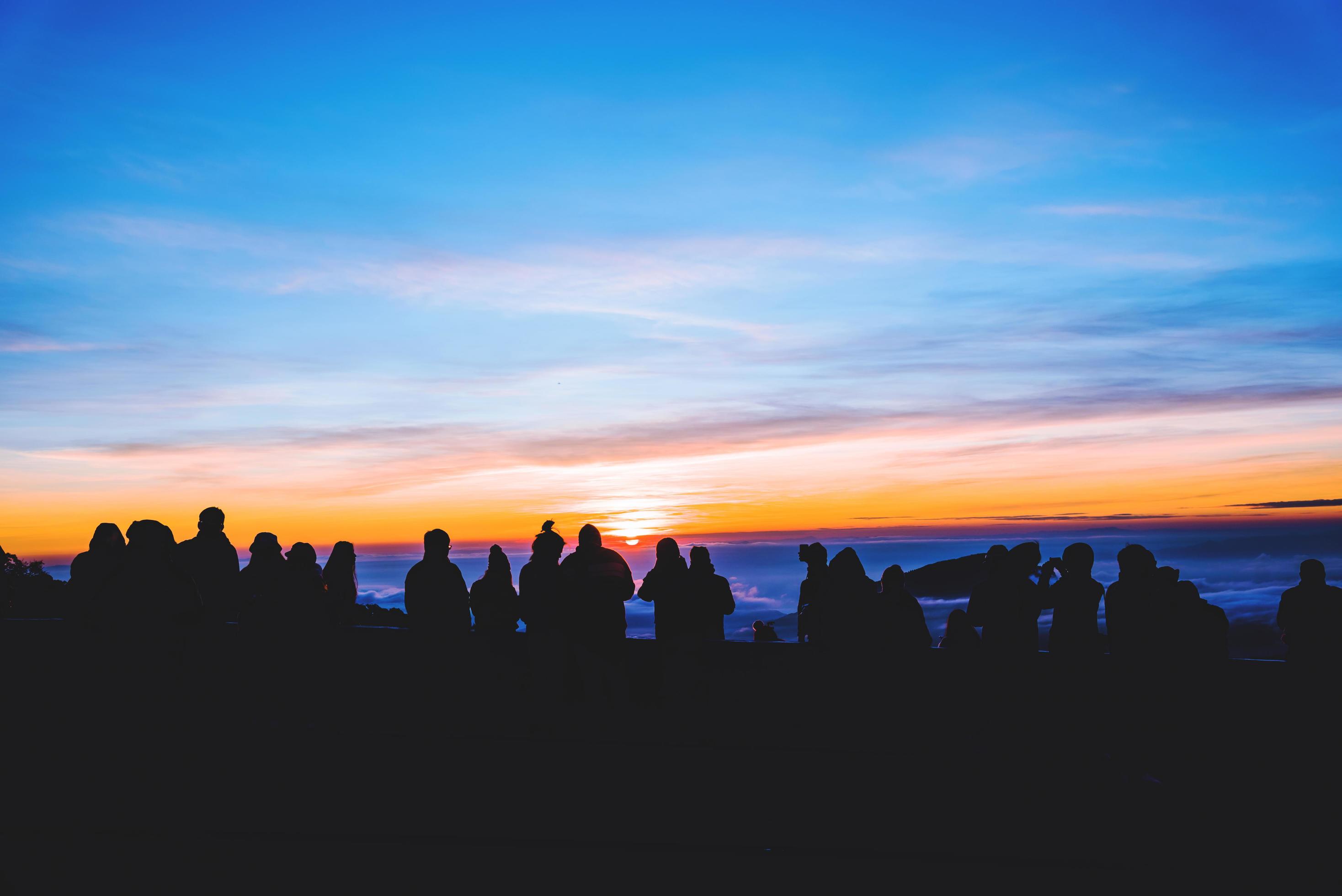 People travel nature. Travel relax. background silhouette People watching Sunrise and photographing Stock Free