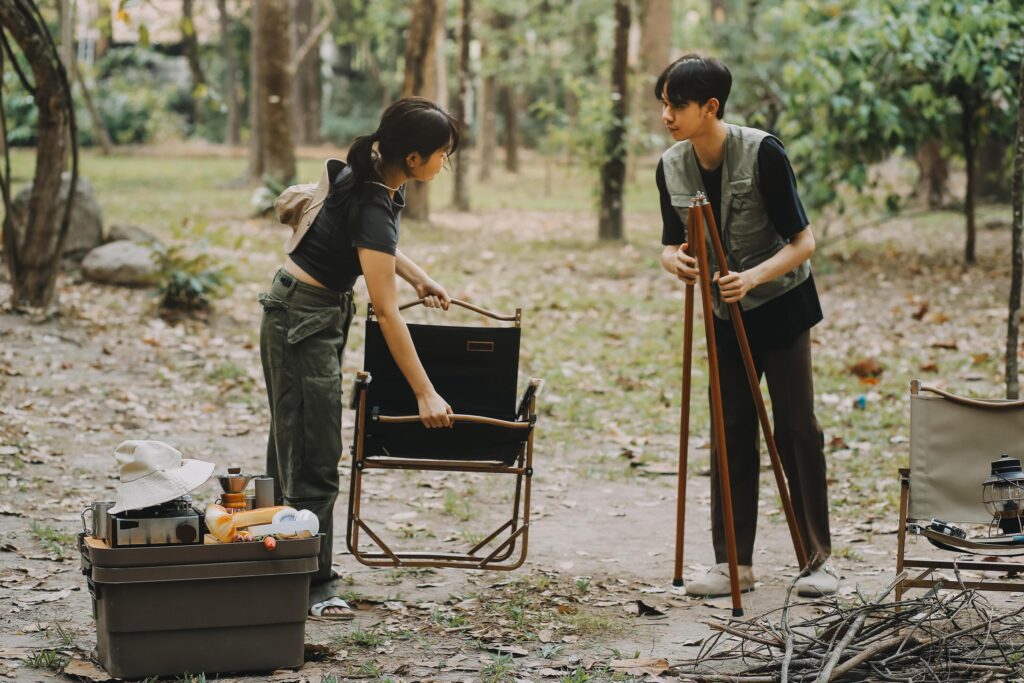 Asian couple sweet in tent inside on they camping trip, traveller relax and sleep togather in out door and camping trip Stock Free