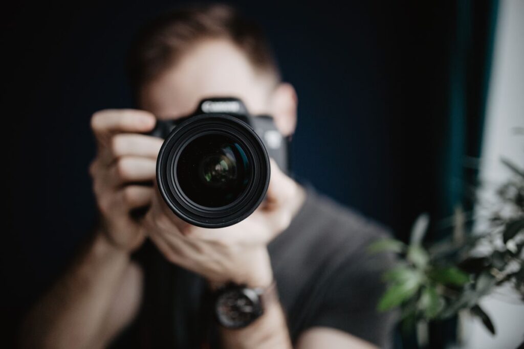 Young man taking photos Stock Free