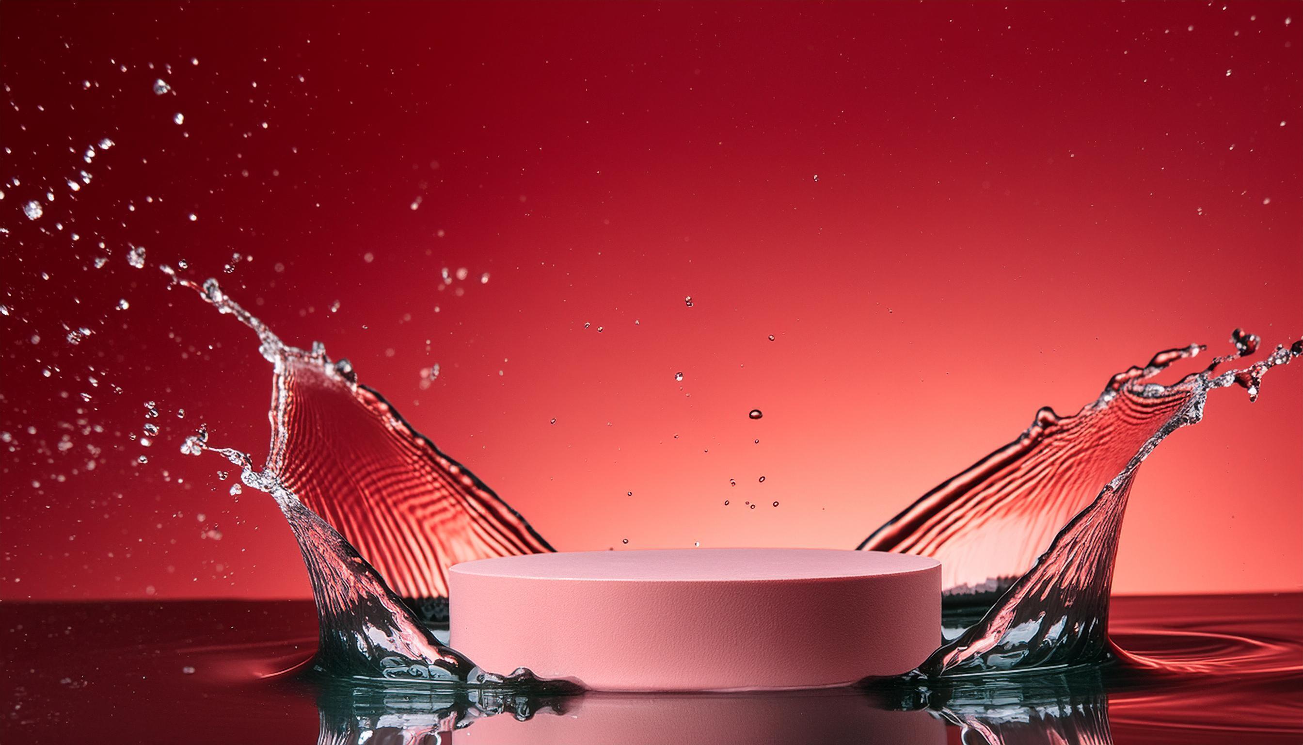 empty pink podium mockup with water splash on a red gradient background for product display Stock Free