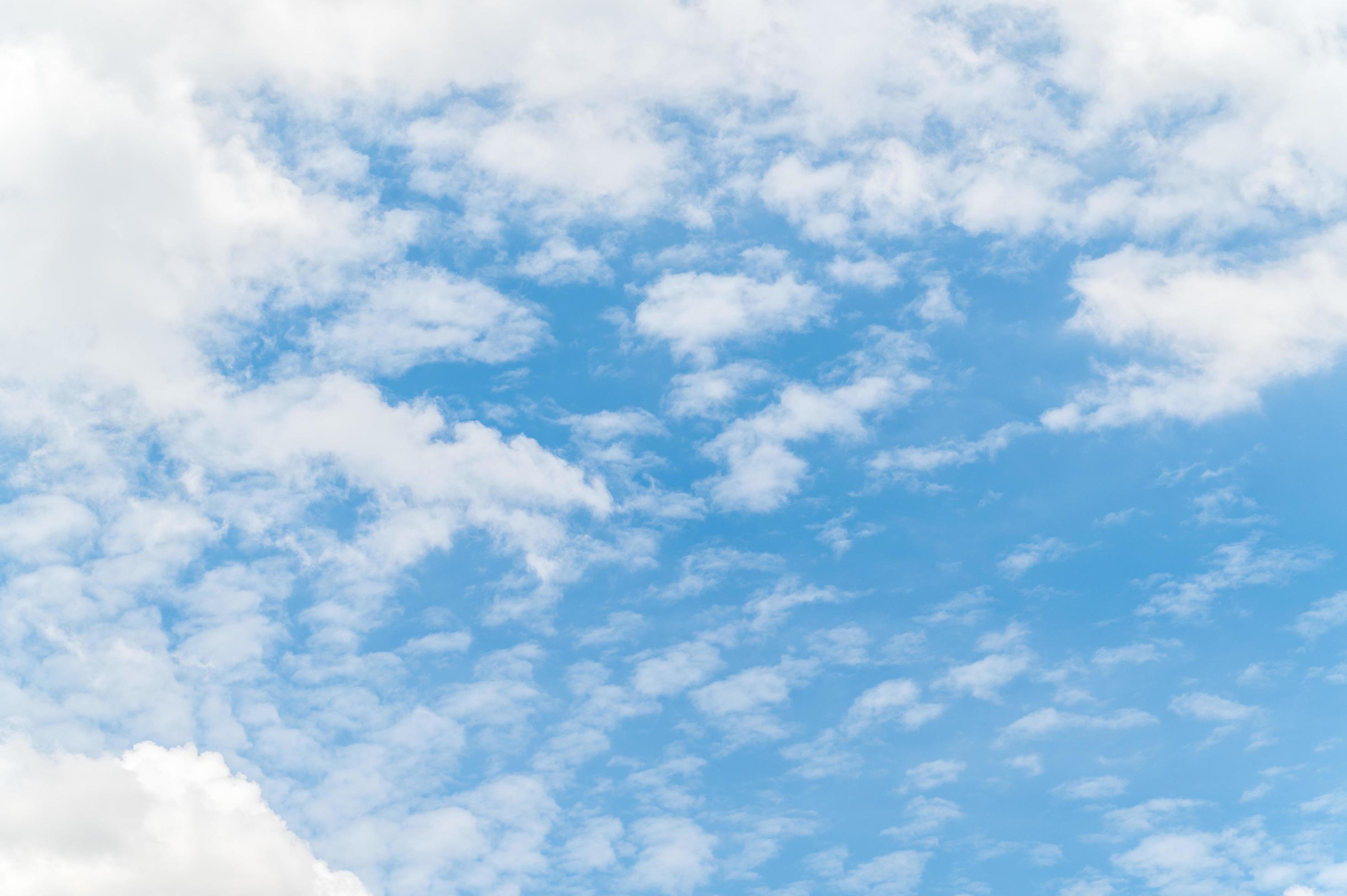 Nature background from white clouds in sunny day. Beautiful white fluffy clouds in blue sky. Stock Free