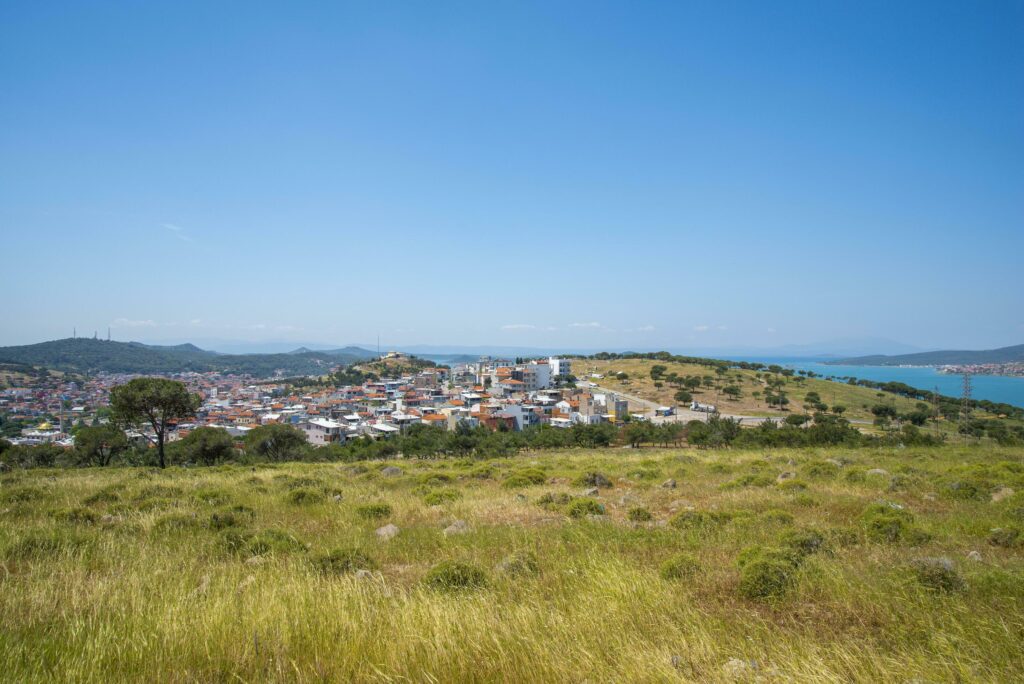 A Turkish small town overlooking the sea and a green field on a summer and sunny day. Stock Free