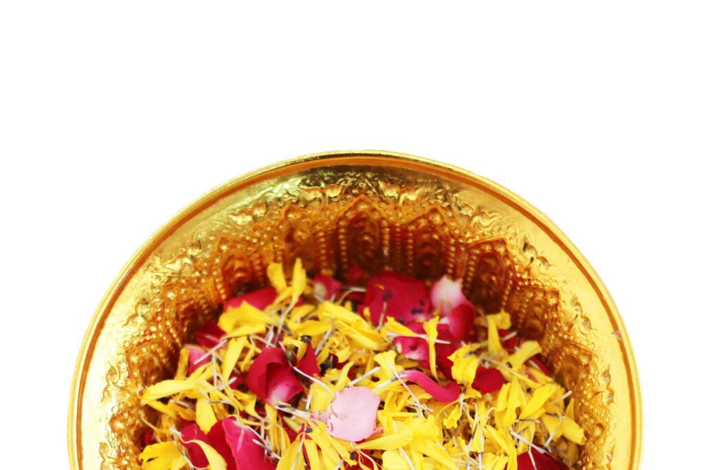 Red rose and Marigold flowers petals in gold tray isolated on white background in tradition Thai wedding ceremony and Buddhism in the temple Stock Free