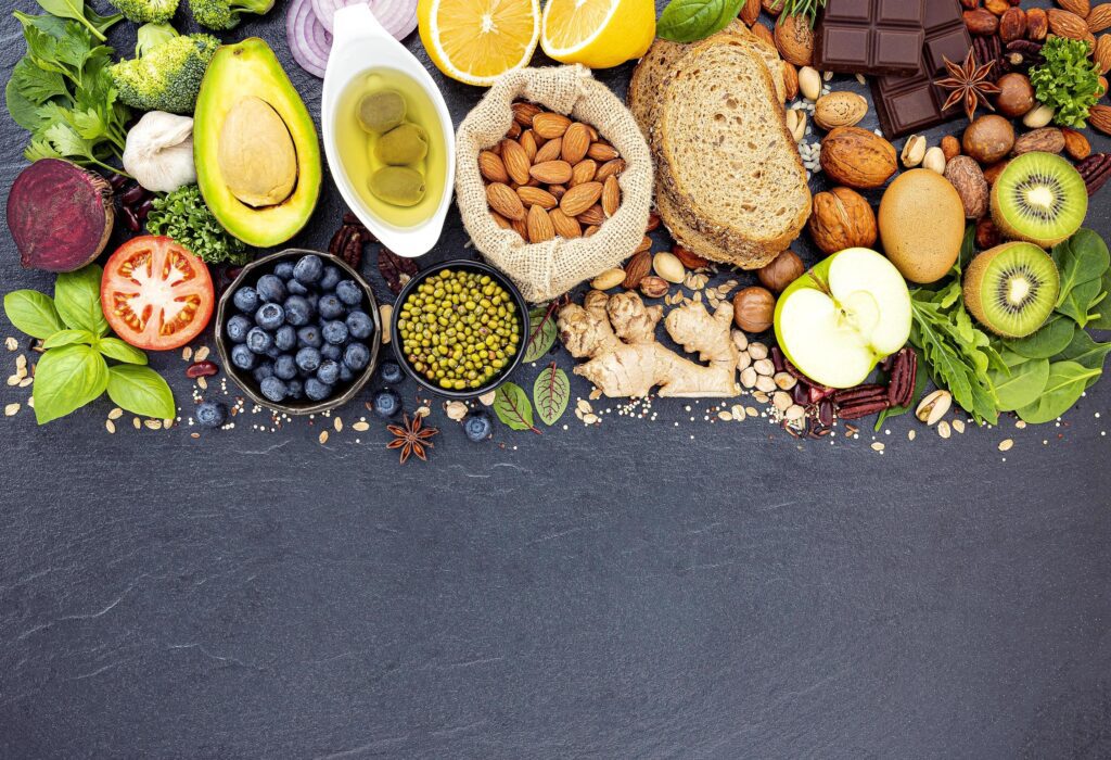 Healthy foods flat lay on dark slate Stock Free