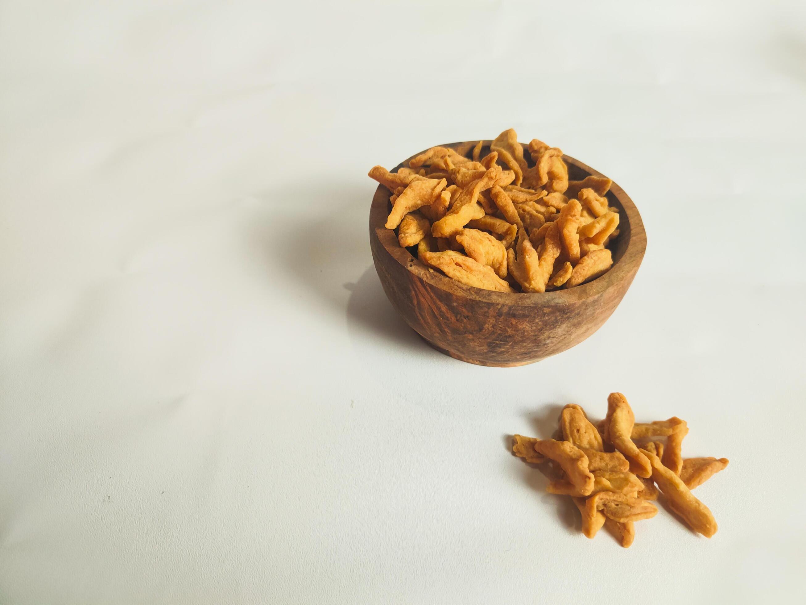 photography of cimi-cimi snack food in a wooden bowl on a white background Stock Free