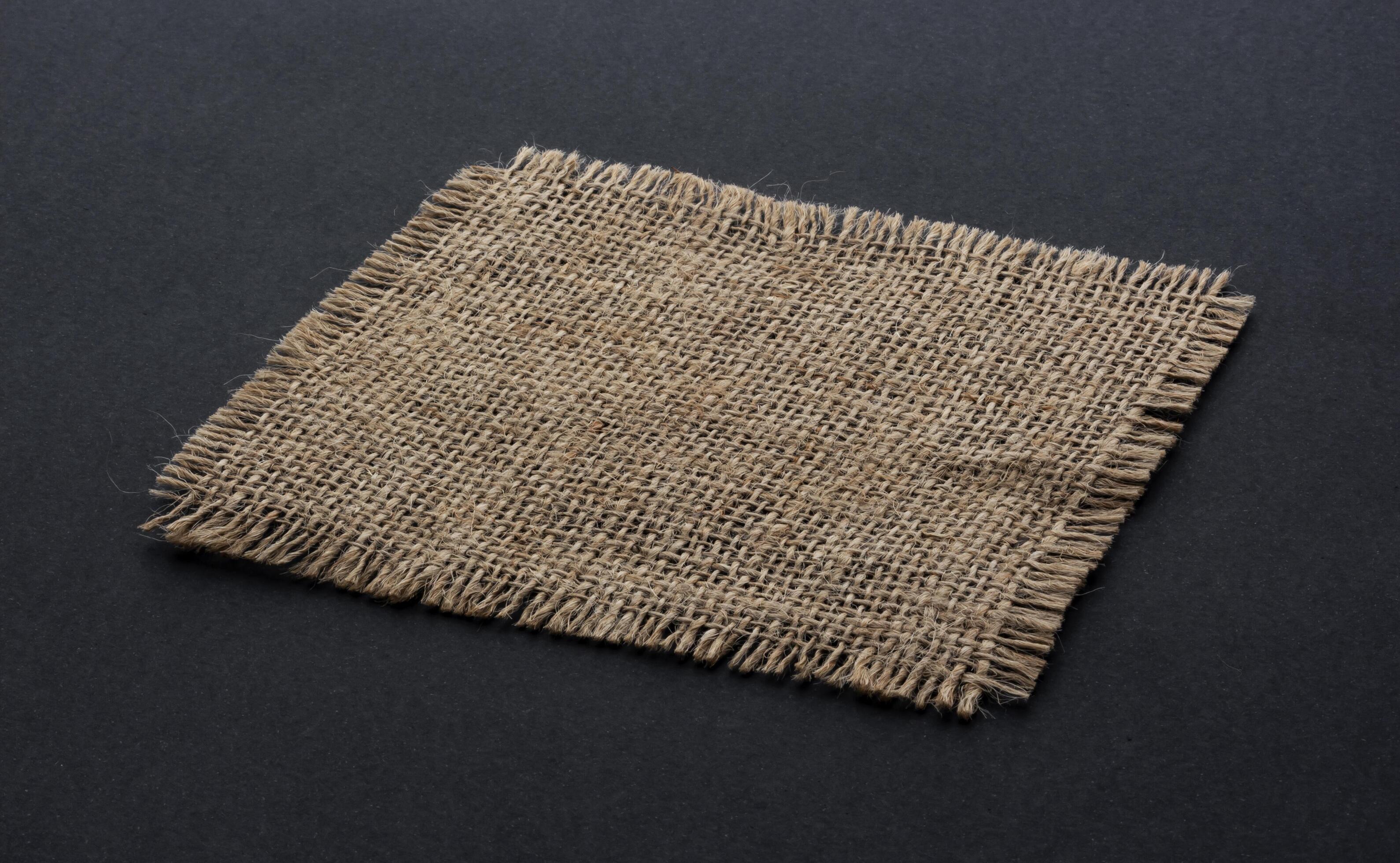 
									Old burlap fabric napkin on black background Stock Free