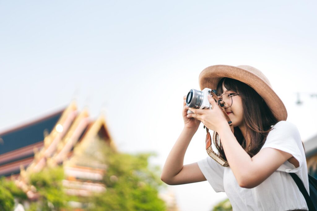 Young asian girl traveller sightseeing around Bangkok with camera. Stock Free