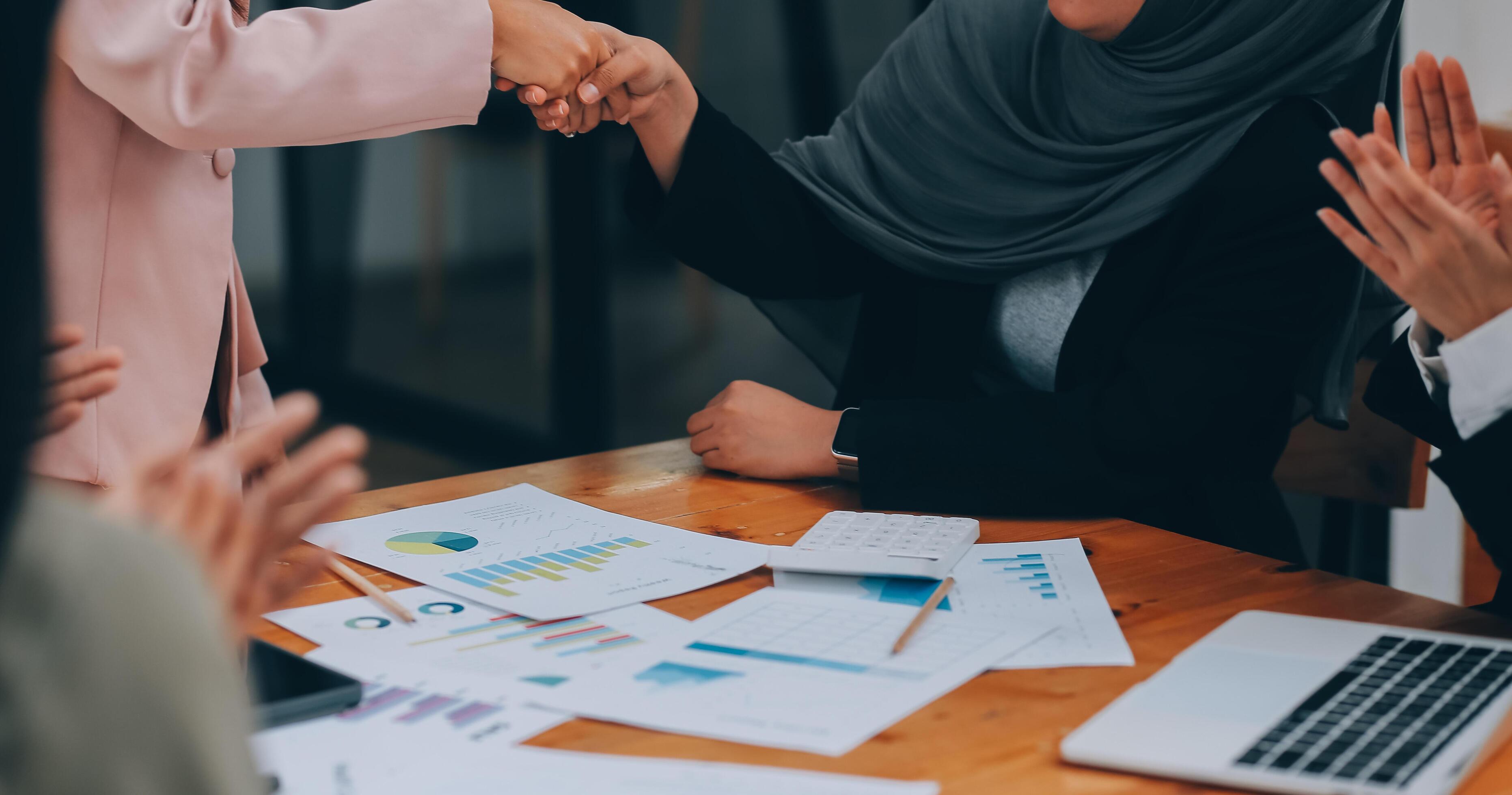 Businesswoman partnership handshake concept. Two young asian business professionals celebrating teamwork in an office, Colleague in meeting. Stock Free