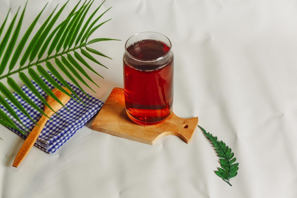 photography of a glass of tea and several elements on a white background Stock Free