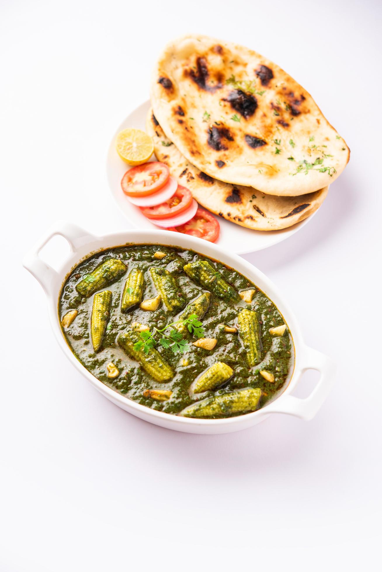 palak baby corn sabzi also known as spinach makai curry served with rice or roti, Indian food Stock Free