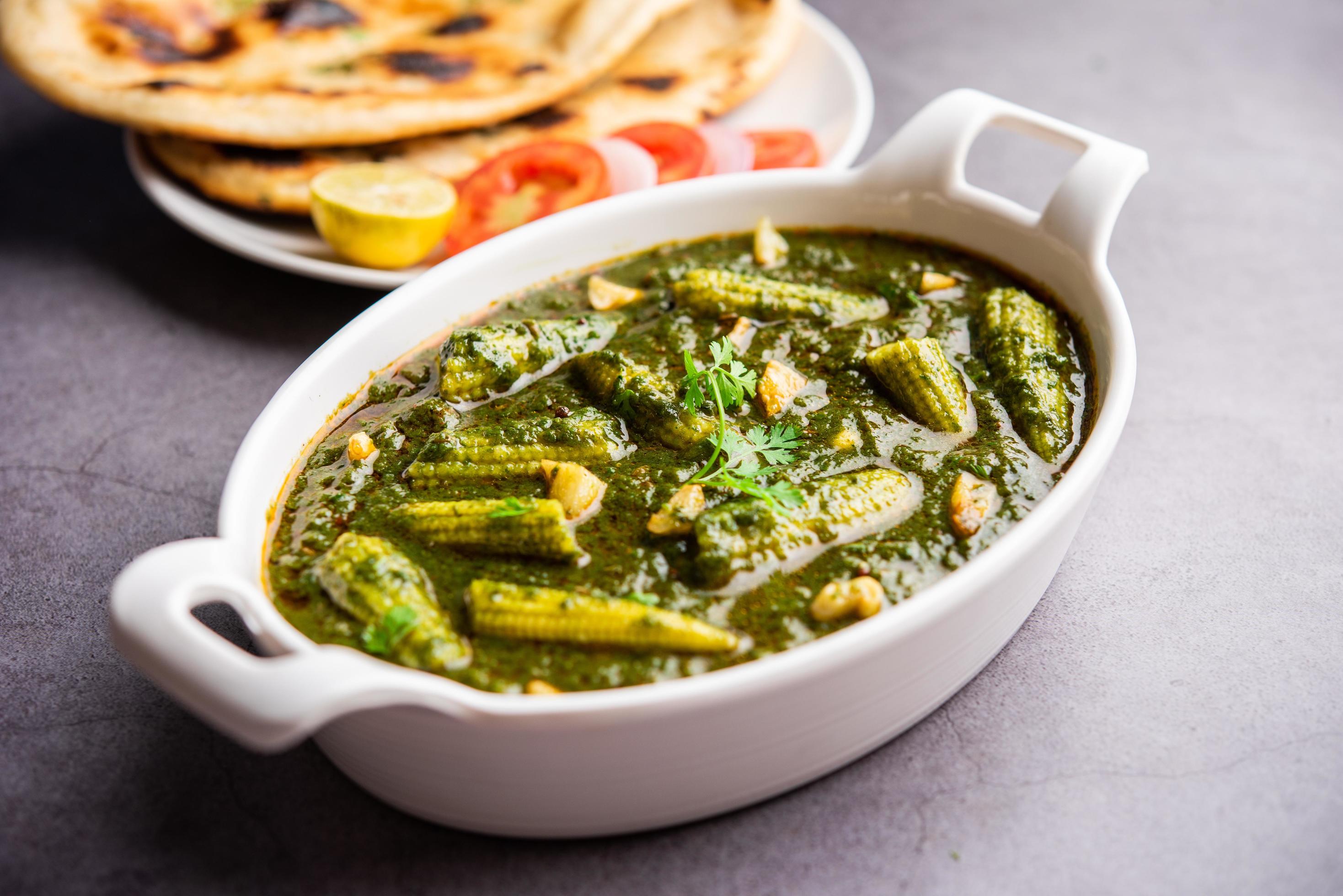 palak baby corn sabzi also known as spinach makai curry served with rice or roti, Indian food Stock Free