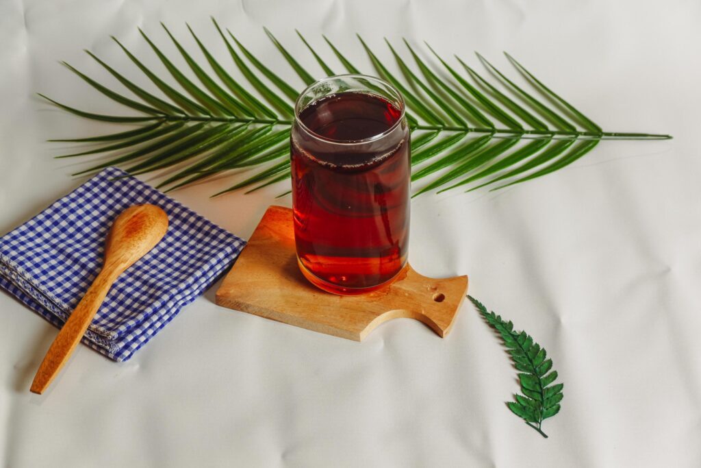 photography of a glass of tea and several elements on a white background Stock Free