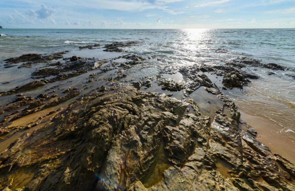 Rock and black sand at Nangthong natural black beach in thailand Stock Free