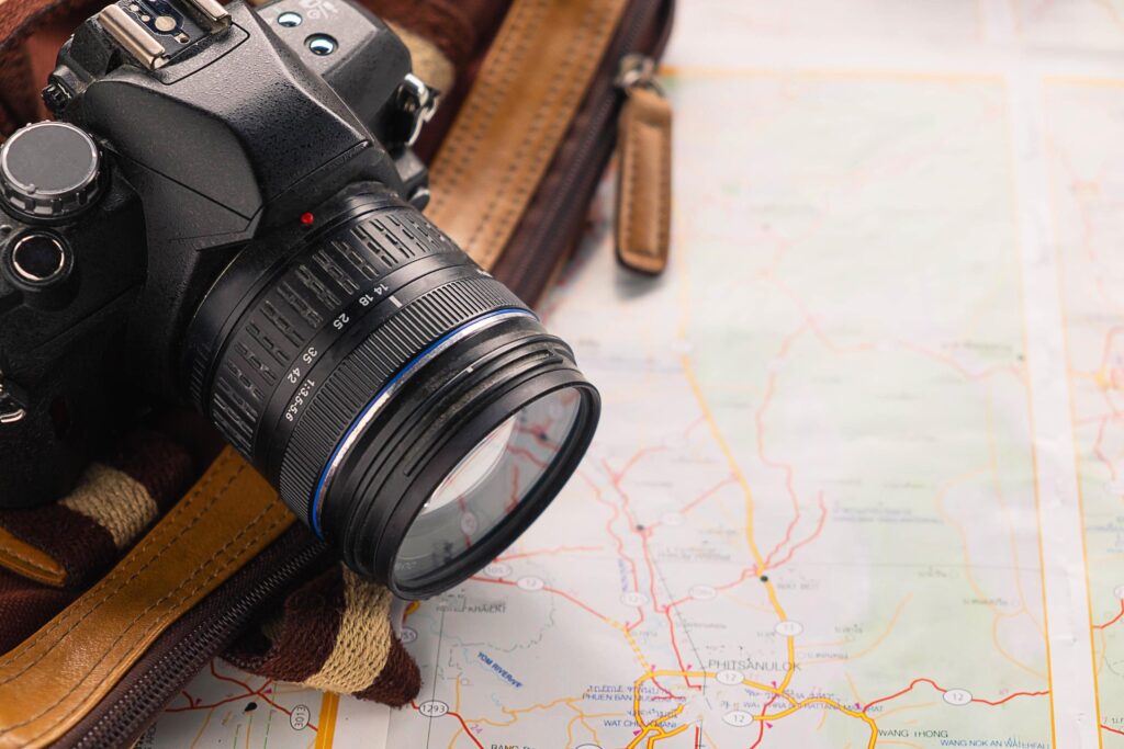 Camera and bag on a map Stock Free