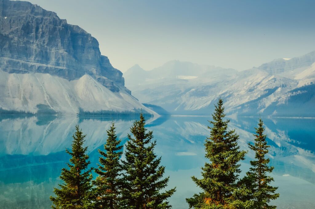 Mountain reflection in blue water with trees Stock Free