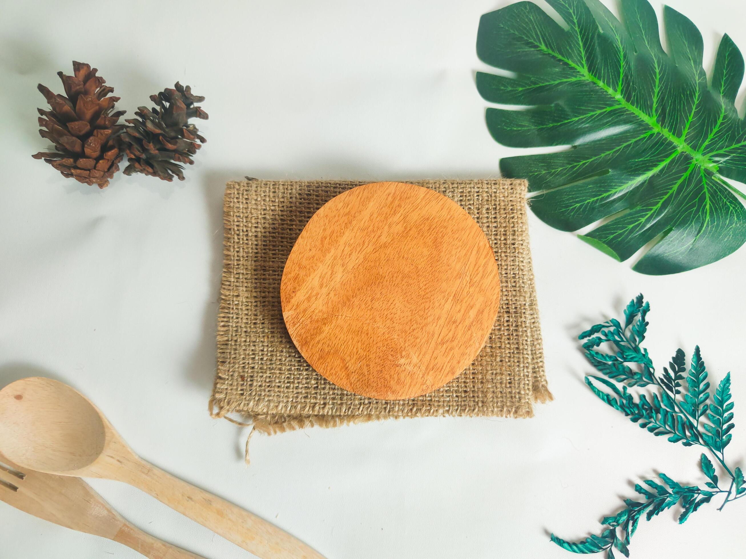 photography of circular wooden coasters with leaf ornaments on a white background suitable for mock-ups Stock Free