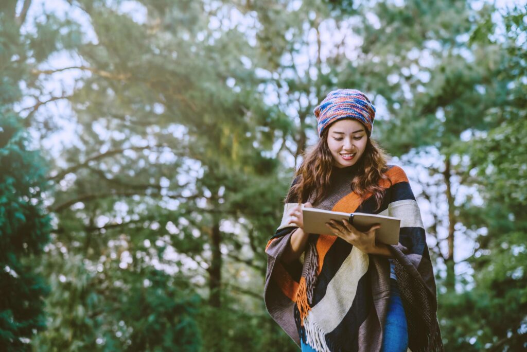 Asian woman travel nature. Travel relax. Study read a book. Nature Education Write a note At public park in summer. In Thailand Stock Free