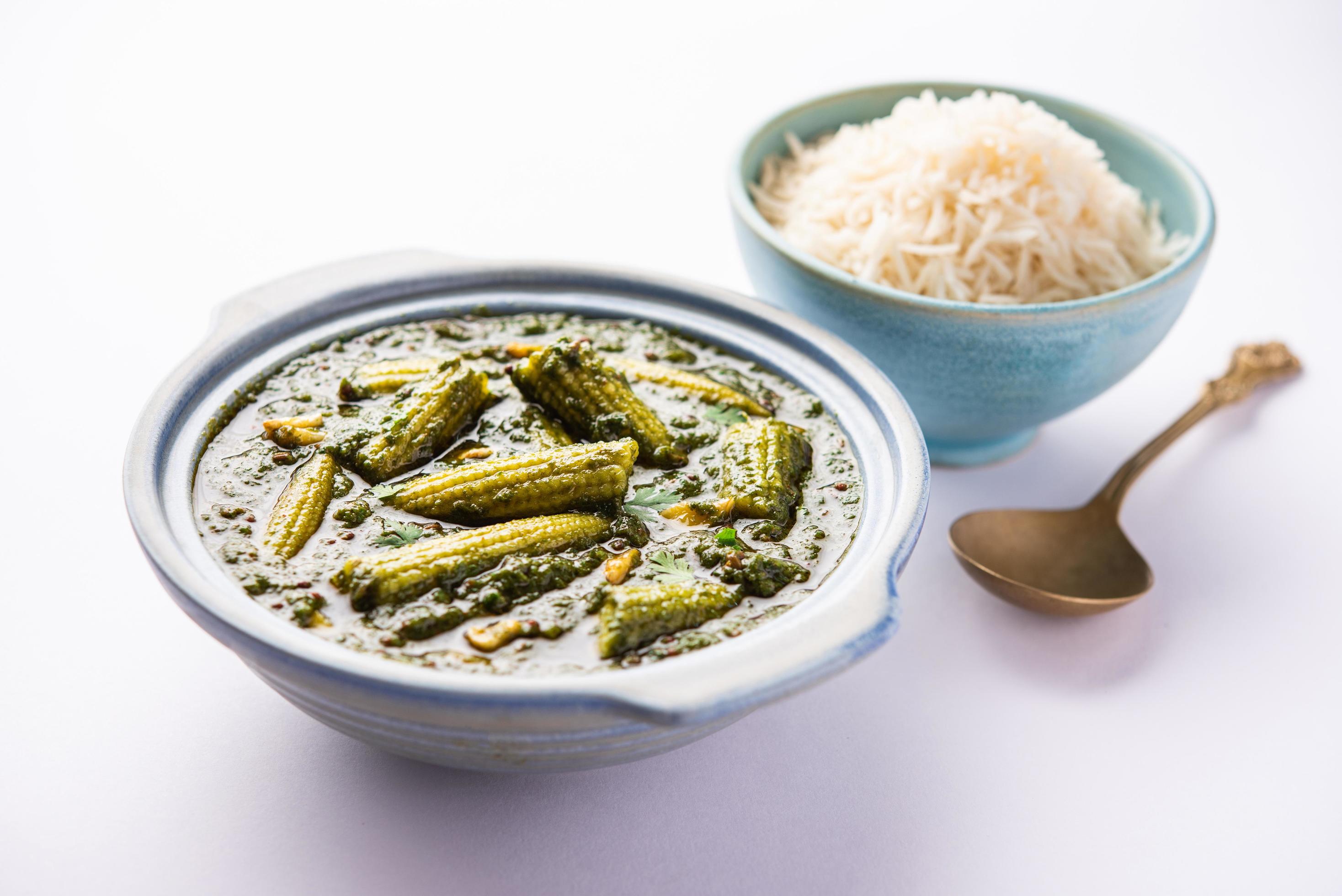 palak baby corn sabzi also known as spinach makai curry served with rice or roti, Indian food Stock Free