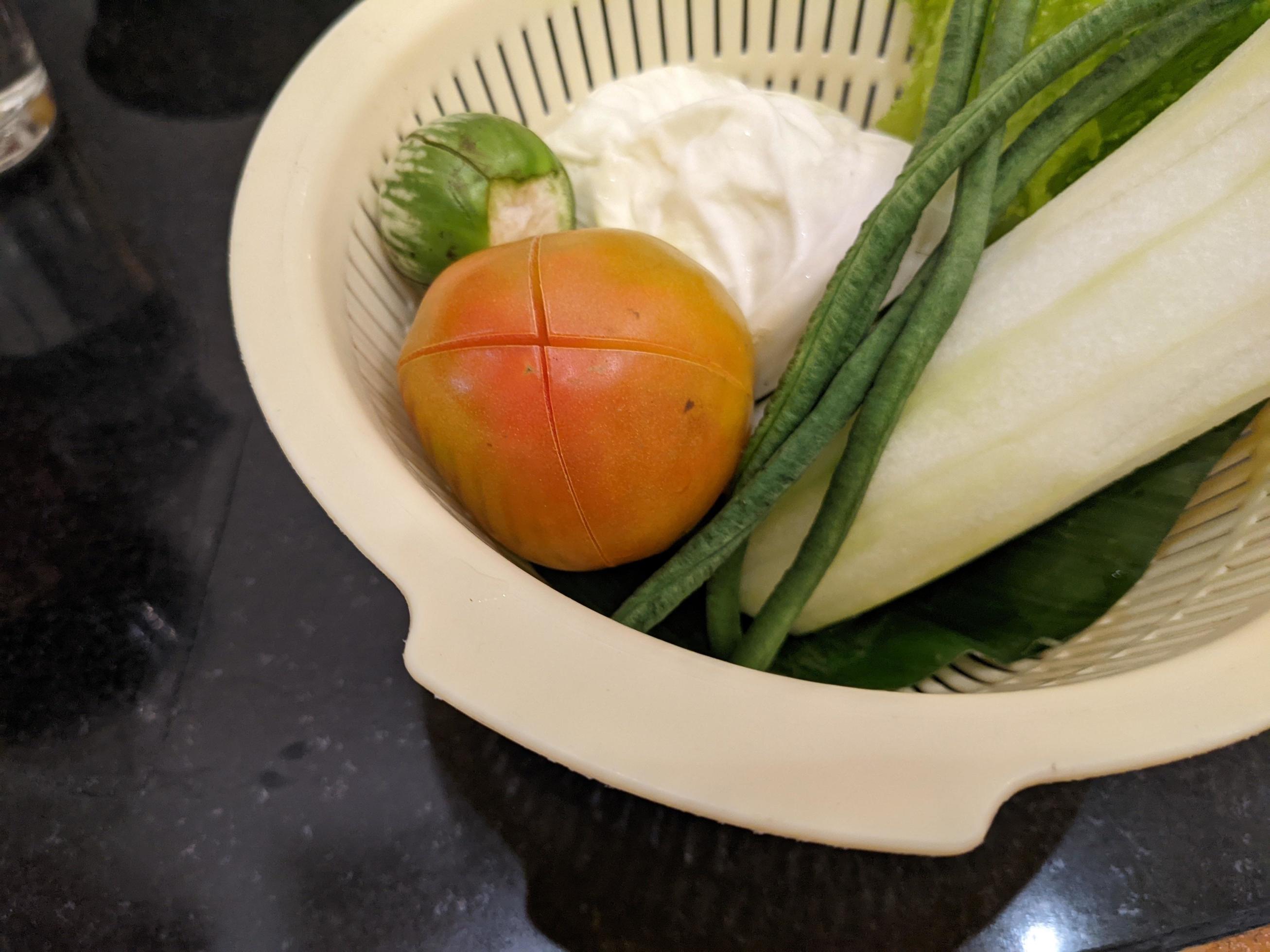 Close up photo of salad on the white basket, tomato, eggplant and cabbage. The photo is suitable to use for vegan food background, poster and food content. Stock Free