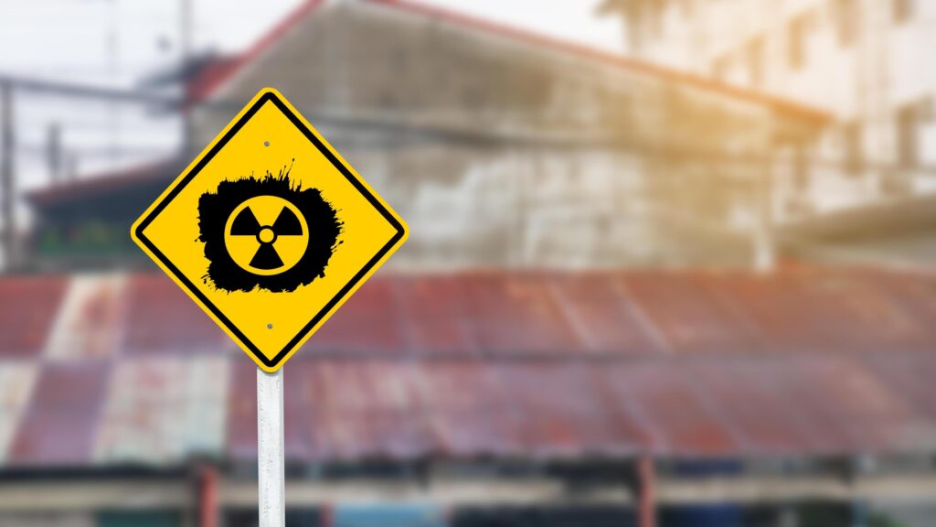 Yellow radioactive sign on blur background Stock Free