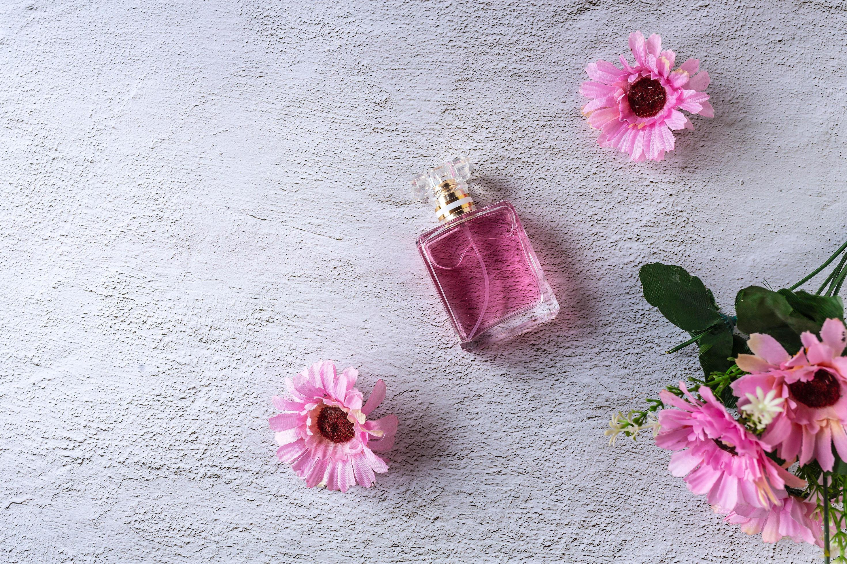 pink perfume bottle with pink flowers Stock Free