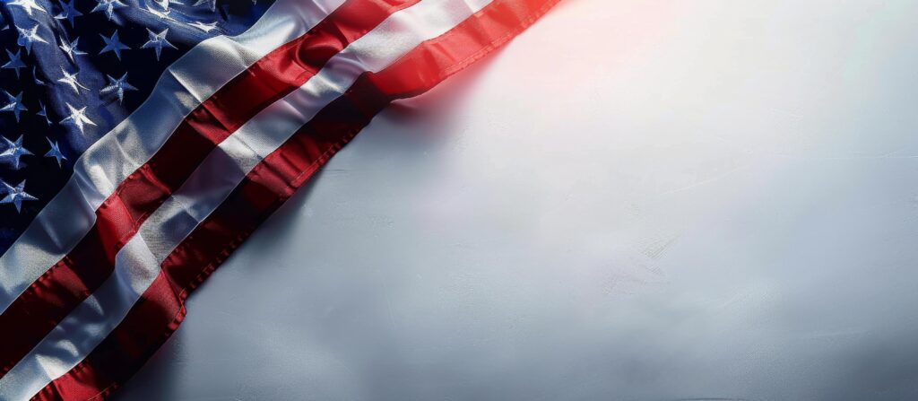 American Flag Draped Over White Background With Sunlight Stock Free