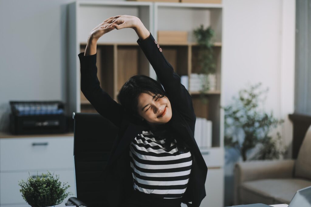 Office asian business woman stretching body for relaxing while working with laptop computer at her desk, office lifestyle, business situation Stock Free