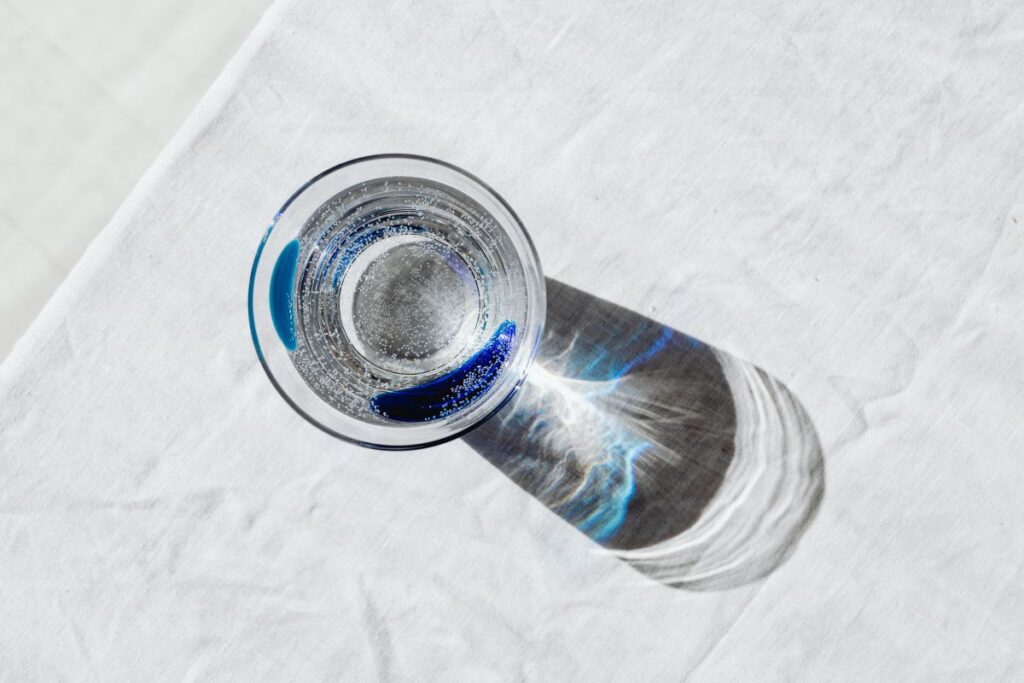 Glass of water on the linen tablecloth Stock Free