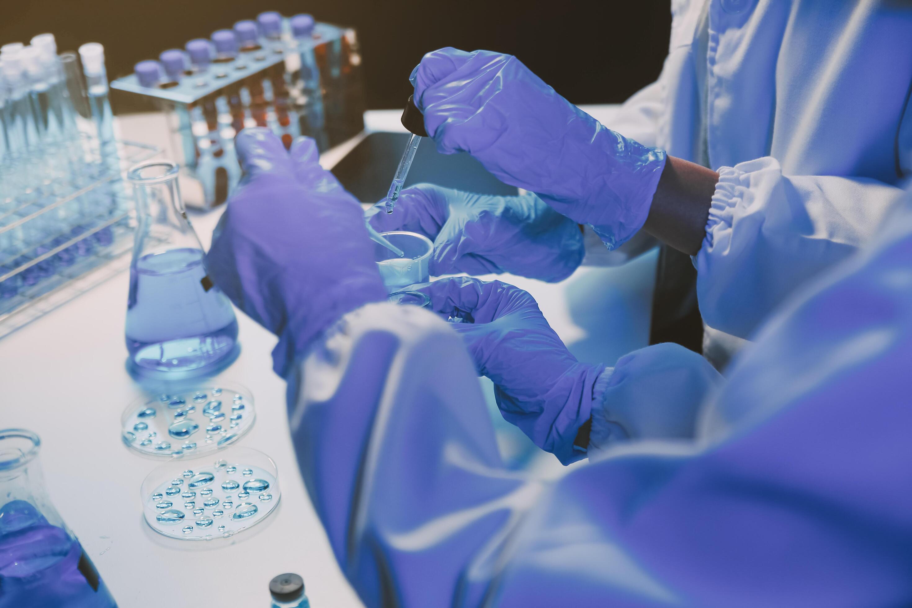 chemist,scientist hand dropping chemical liquid into test tube, science research and development concept Stock Free