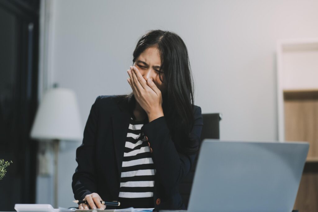 Office asian business woman stretching body for relaxing while working with laptop computer at her desk, office lifestyle, business situation Stock Free