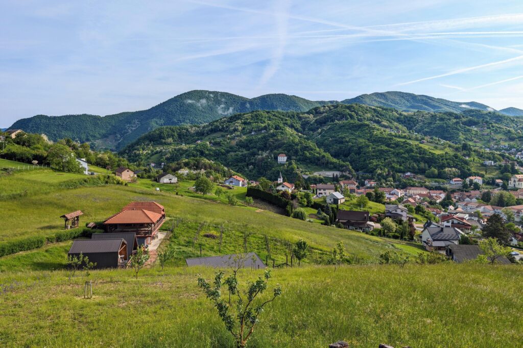 Hillside landscape, house on green hill, mountains in background, Krapina, Croatia, Hrvatsko zagorje Stock Free