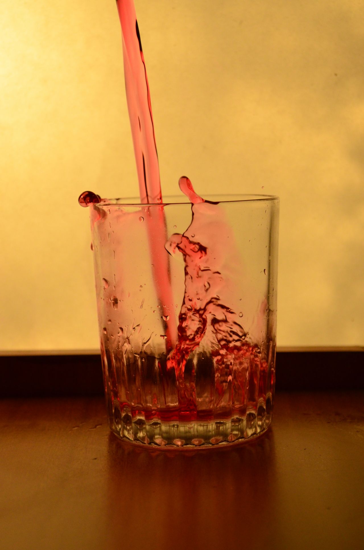 Red Liquid Falling In A Glass Stock Free