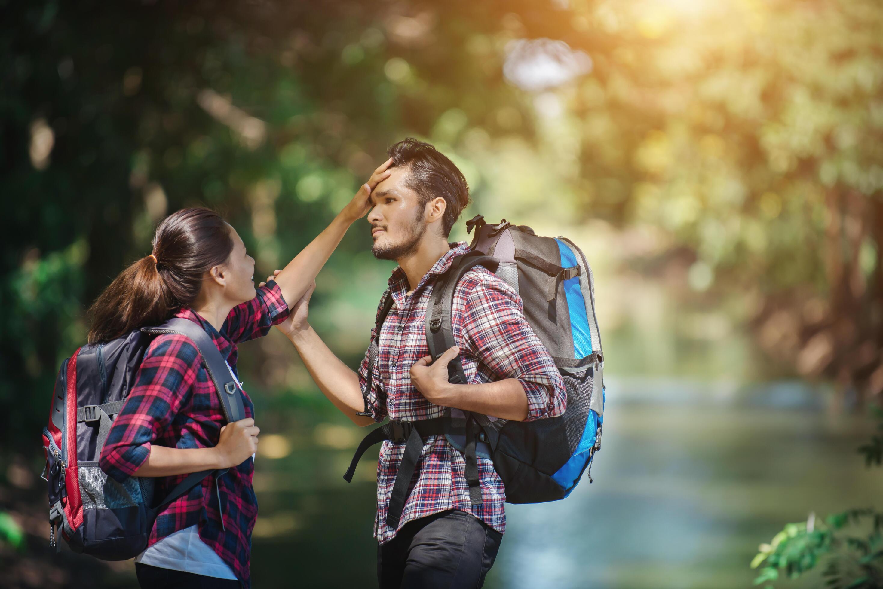 Hiking couple in forest together. Adventure travel vacation. Stock Free