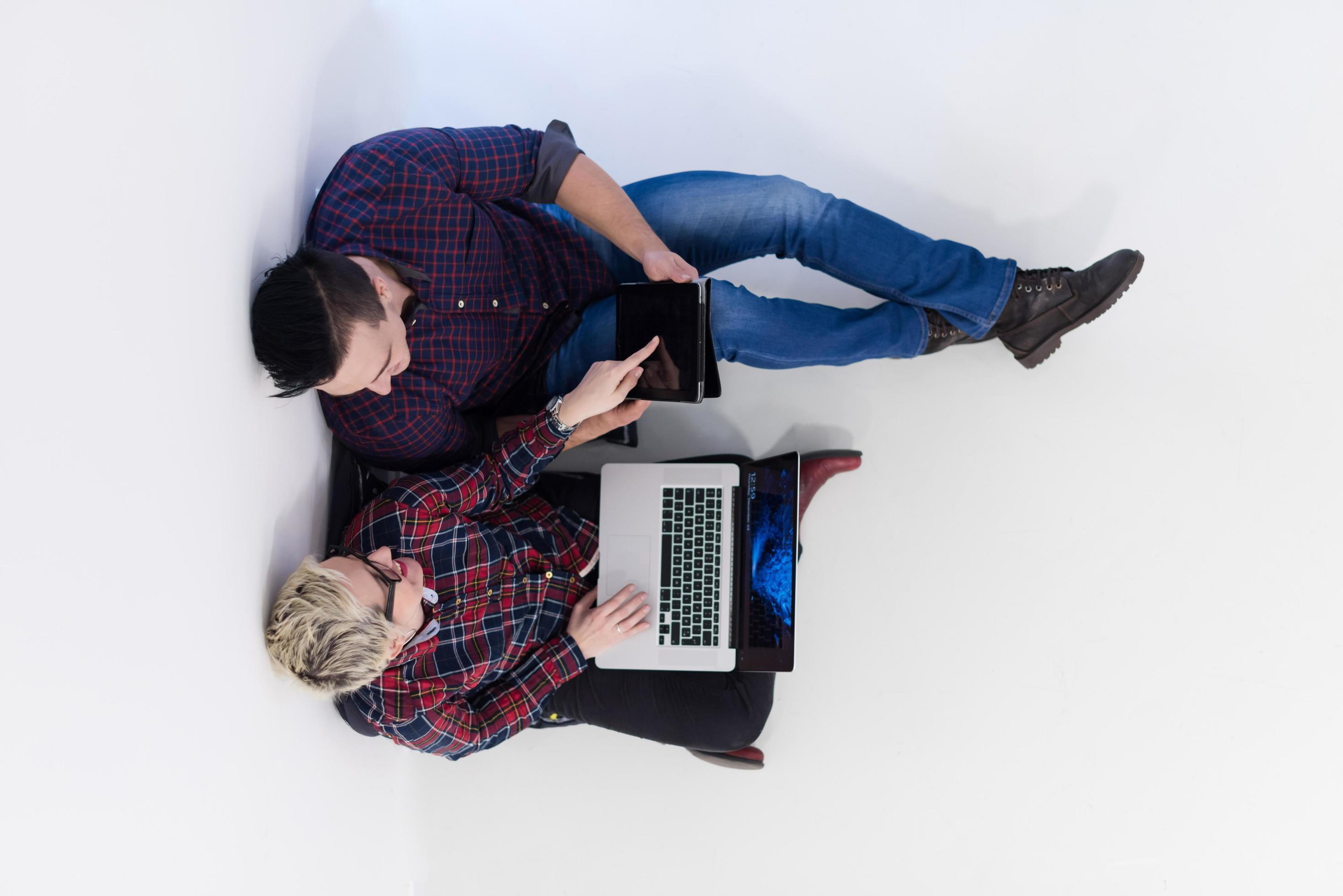 top view of couple working on laptop computer at startup office Stock Free