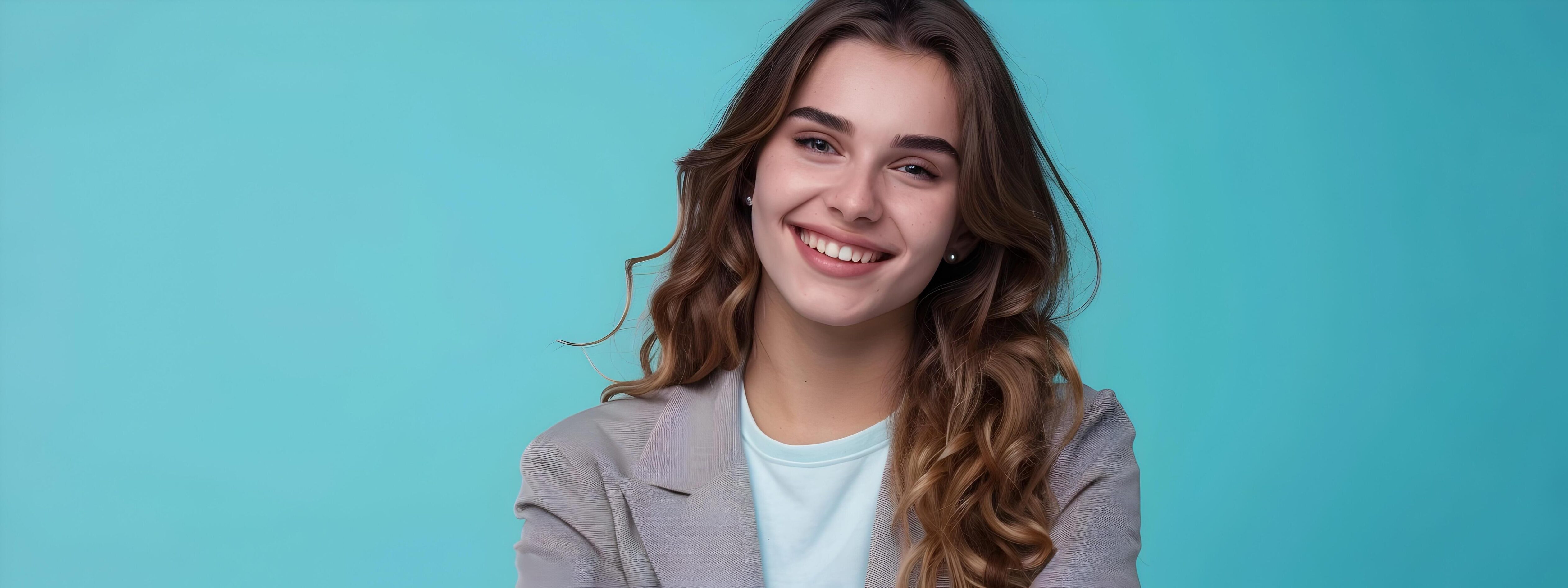 Confident and Friendly Young Professional Woman in Business Attire Posing with Warm Smile on Colorful Background Stock Free