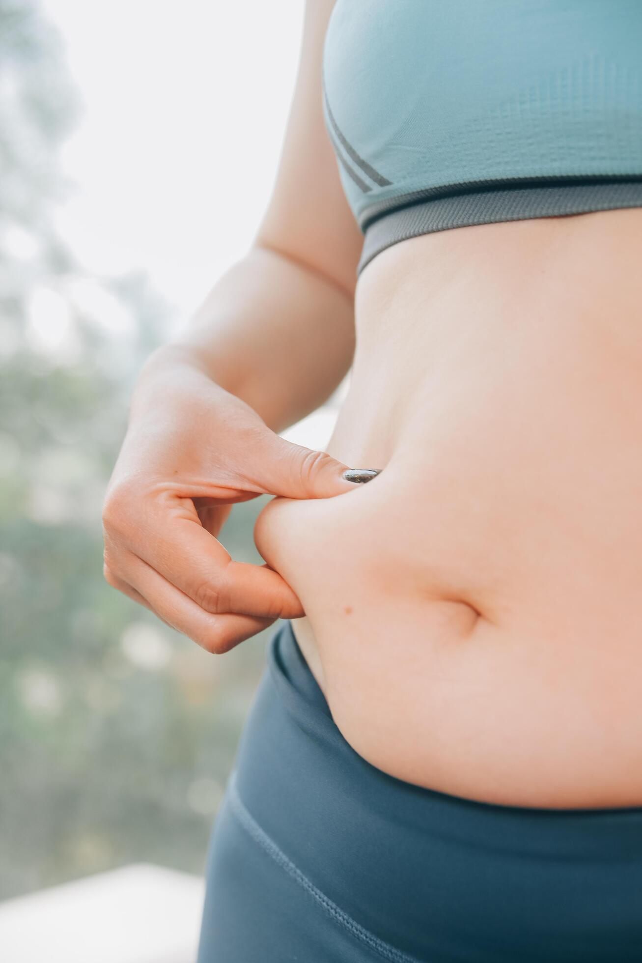 fat woman, fat belly, chubby, obese woman hand holding excessive belly fat with measure tape, woman diet lifestyle concept Stock Free