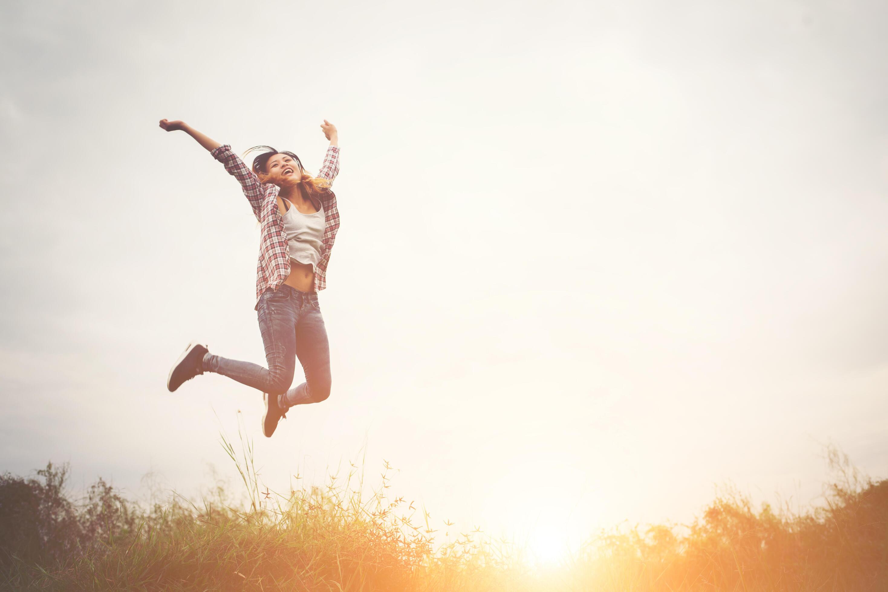 Beautiful hipster woman jump up high, Freedom enjoying with the nature around. Stock Free